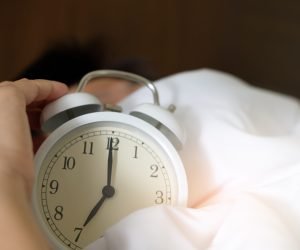 The hand under the blanket extends to the alarm clock in the morning, with light orange.